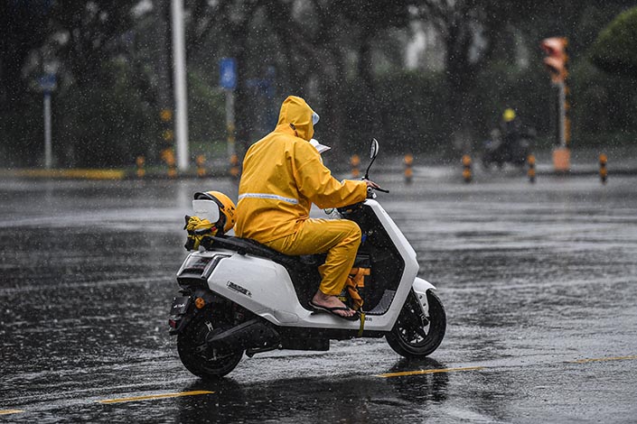 A Meituan takeout worker rides in the heavy rain in Haikou, South China’s Hainan province,  in October 2020. Photo: VCG