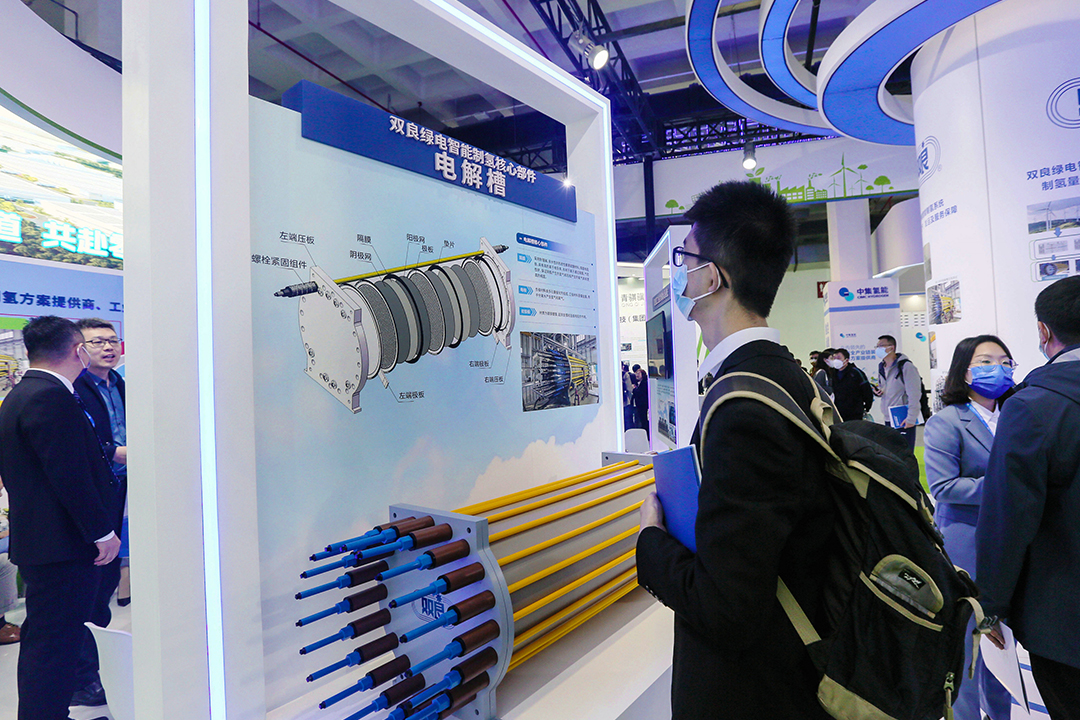 A visitor looks at a diagram of an electrolysis cell on Sunday at the China International Clean Energy Expo in Beijing. Photo: VCG