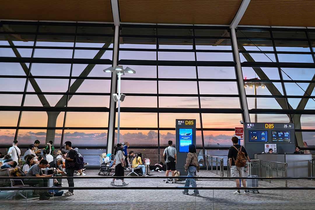 Passengers wait at Shanghai Pudong International Airport on Saturday. Photo: VCG